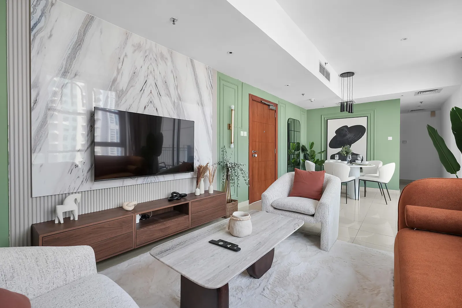 Marble-effect TV wall with a fluted base panel and a walnut TV unit, next to sage moulding